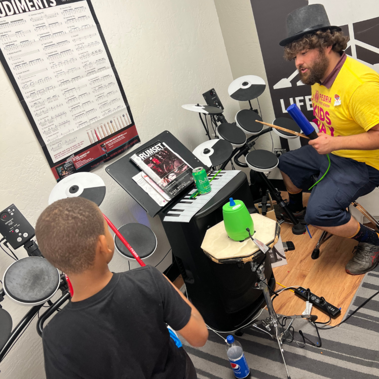 Teacher showing a student drums