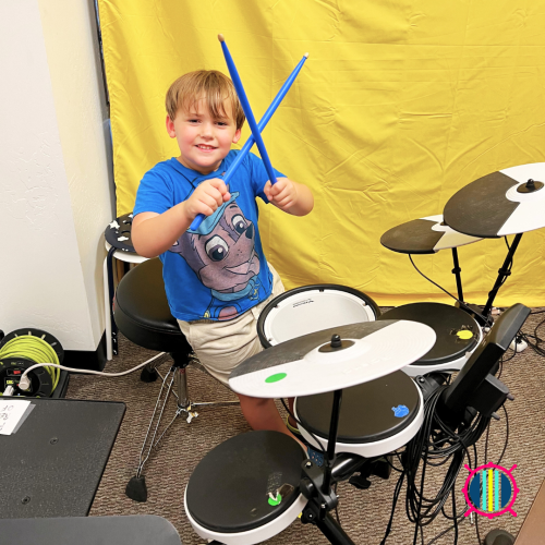 Child holding drum sticks